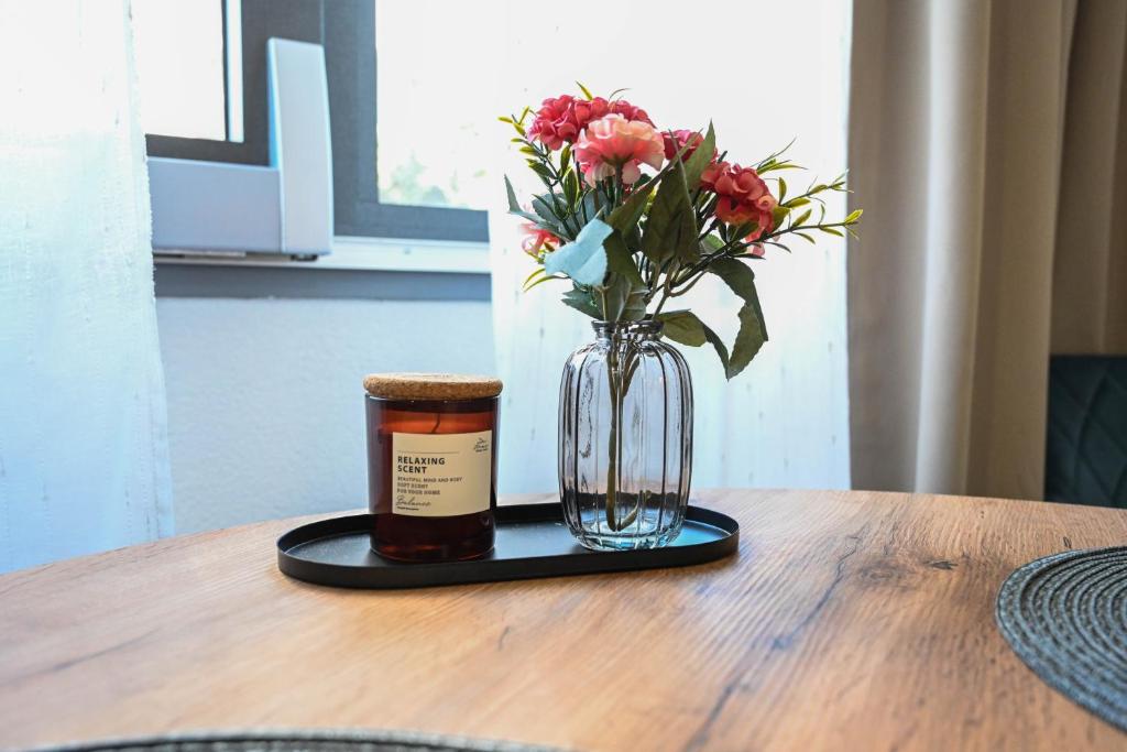 Fresh flowers and a scented candle on a tray on the oak dining table